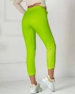 Spodnie Dresowe^Royalfashion Neonowe żółte damskie spodnie dresowe z naszywką- Odzież żółty