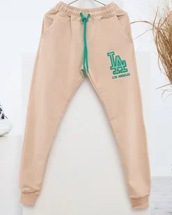 Spodnie Dresowe^Royalfashion Beżowe damskie spodnie dresowe z kolorową naszywką beżowy