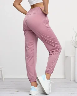 Spodnie Dresowe^Royalfashion Ciemnoróżowe damskie spodnie dresowe typu joggery ciemnoróżowy