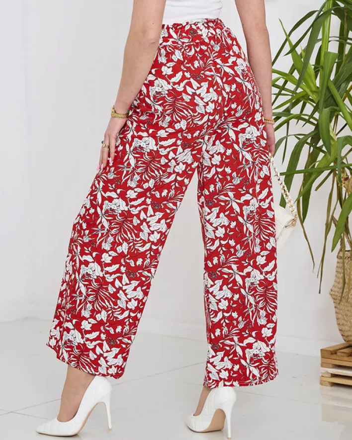 Spodnie Materiałowe^Royalfashion Damskie czerwone spodnie typu palazzo z białymi kwiatami czerwony