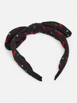 Akcesoria Do Włosów^Royalfashion Dziecięca opaska do włosów z kokardką z printem w wisienki czarny