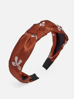 Akcesoria Do Włosów^Royalfashion Opaska do włosów satynowa z pleceniem z nadrukiem brązowy