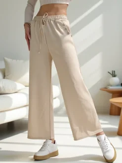 Spodnie Materiałowe|Spodnie Dresowe^Royalfashion Wiskozowe szerokie spodnie damskie dresowe z cyrkoniami beżowy